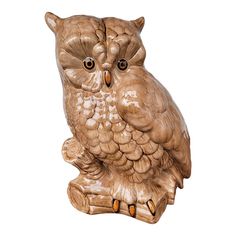 an owl statue sitting on top of a wooden stump