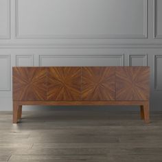 a large wooden cabinet sitting on top of a hard wood floor next to a wall