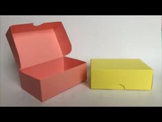 an open box sitting on top of a table next to a yellow box with a lid