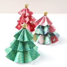 three origami christmas trees on a white table