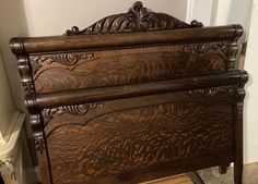 an antique wooden bed frame with intricate carvings