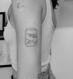 a woman with a small tattoo on her arm