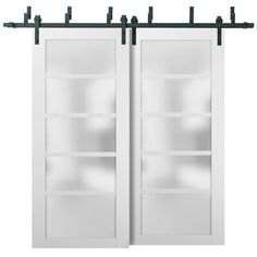 two white sliding doors with black handles