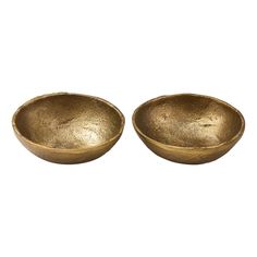 two gold bowls sitting next to each other