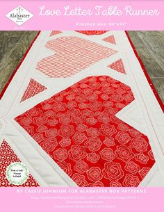 a red and white table runner on a wooden floor with the words love letter table runner