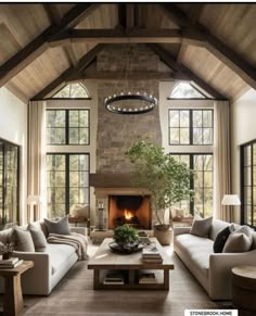 a living room filled with furniture and a fire place in the middle of a room