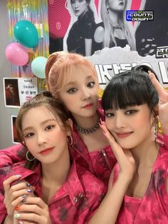 three girls posing for the camera with balloons in the background