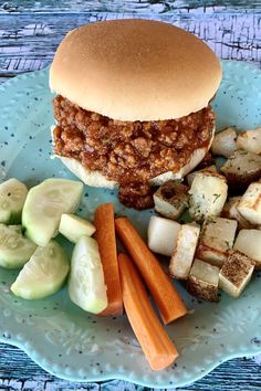 a sandwich and vegetables on a blue plate