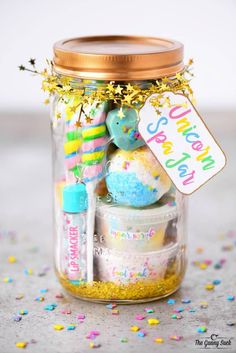 a jar filled with lots of colorful markers and confetti