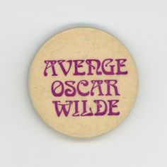 a badge with the words average oscar wilde written in purple ink on top of it