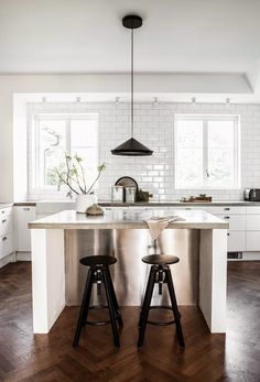 two stools sit at the center of this kitchen island