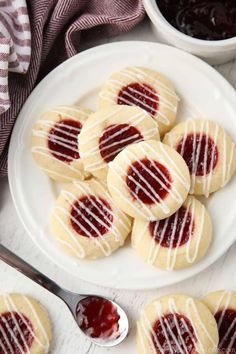 raspberry thumbprint cookies on a white plate