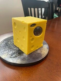 a yellow object sitting on top of a wooden table