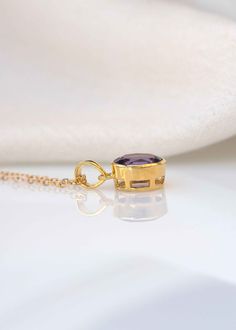 "Add a hint of color to your jewelry collection with our classic oval Amethyst gold necklace handmade in .925 silver base. This classic with a touch of modern necklace features a single 11mm x 9mm deep purple genuine amethyst set in a sturdy bezel setting. Comes with flat cable chain to create a unique look in the length of your choice. DIMENSIONS: Stone - 11mm x 9mm Diameter, Pendant total length 20mm Model is wearing 20\" long chain MATERIAL: 925 sterling silver, natural genuine amethyst stone Gold Amethyst Jewelry With Polished Finish, Timeless Gold Jewelry With Amethyst, Timeless Gold Amethyst Jewelry, Classic Amethyst Oval Pendant Necklace, Amethyst Pendant Necklace, Amethyst Set, Modern Necklace, Amethyst Necklace Pendant, Amethyst Gold