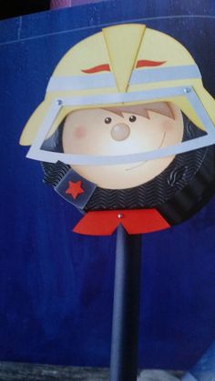 a paper cut out of a cartoon character wearing a helmet