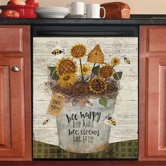 a kitchen cabinet with a potted plant on it and a sign that says be happy