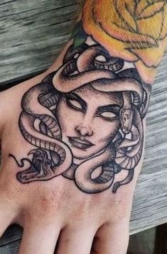 a person's hand with a tattoo on it and a rose in the middle