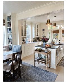 a kitchen with white cabinets and an island