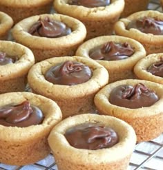 there are many cookies with chocolate frosting on the cooling rack in front of them