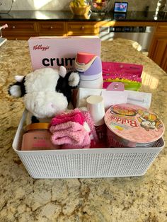 a white basket filled with items on top of a counter