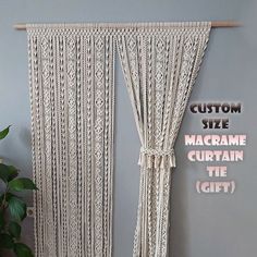 a macrame curtain hanging on the wall next to a potted plant