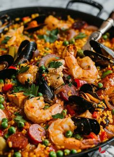 a skillet filled with seafood and rice