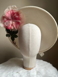 "This is a vintage 1950s hat featuring a chic statement flower on both the inside and outside of the brim. The hat is a deep ivory tone and is trimmed with an ivory velvet bow ribbon. This hat has its original designer tag which reads 'Reproduction of Maria-Guy 8,Place Vendome Paris.' This hat is in excellent vintage condition with only a few sections of faint discoloration to note.  Measurements: Interior Circumference: 19.5\" / Inside Depth: 1.5\" / Width: 14.5\" ALL SALES ARE FINAL. Unless ot White Vintage Top Hat With Curved Brim, Cream Mini Hats For Vintage Events, Vintage Cream Fascinator For Royal Ascot, Vintage White Fascinator With Curved Brim, Cream Vintage Fascinator For Royal Ascot, Retro Cream Hat With Curved Brim, Vintage Beige Top Hat With Curved Brim, Cream Cloche Hat For Church And Kentucky Derby, Elegant Cream Hat For Vintage Events