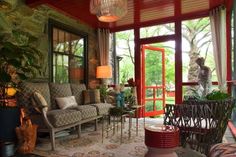 a living room filled with furniture and lots of windows