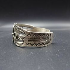 "VINTAGE NAVAJO BRACELET DESCRIPTION: This extraordinary old bracelet will be a cherished addition to your collection of fine vintage Native American jewelry. MEASUREMENTS: Interior of the cuff measures 5 3/8\" with an additional 1 1/8\" slightly adjustable gap. Total circumference: 6 1/2\" Measures 2 3/8\" straight across the widest part (from wrist bone to wrist bone) Bracelet face measures 7/8\" wide (the face of the bracelet, north to south) Cabochon measures 18mm x 13mm WEIGHT: 32.6 grams S Adjustable Antique Concho Jewelry, Antique Adjustable Concho Jewelry, Antique Adjustable Cuff Bracelet, Vintage Engraved Antique Silver Cuff Bracelet, Vintage Antique Silver Bangle Bracelet, Vintage Antique Silver Bangle Bracelets, Vintage Silver Adjustable Cuff Bracelet, Vintage Etched Cuff Bracelet, Vintage Adjustable Silver Cuff Bracelet