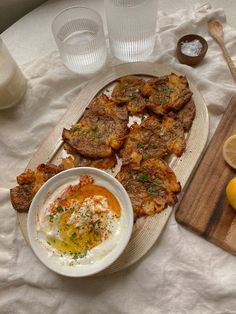 an assortment of food on a table with lemons