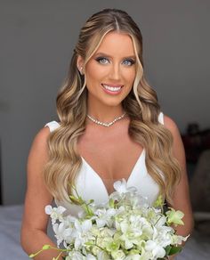 a beautiful woman holding a bouquet of flowers