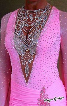 the back of a woman's pink dress with sequins and beads on it