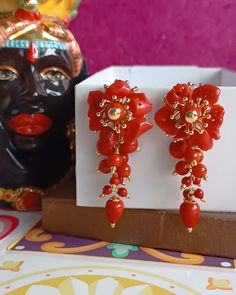 Statement earrings made of: - Smooth Coral Paste (8 mm - 6 mm - 3 mm) mounted as cluster, red color; - Coral paste drops (12 mm x 10 mm), red color; - Brass pins with natural Coral chips glued and open hooks. Lenght : 6,5 cm / 2,36  inches * SHIPPING * Your order will be shipped within 1-3 business days from your purchase. You can choose between 2 shipping methods: STANDARD SHIPPING (without tracking) or REGISTERED MAIL (with tracking). Each chapeau atelier jewel is shipped in a gift box. Thank Red Clip-on Dangle Jewelry, Elegant Red Dangle Clip-on Earrings, Elegant Flower Earrings With Round Beads As Gift, Elegant Round Beads Flower Earrings As Gift, Formal Red Flower Earrings For Pierced Ears, Elegant Red Handmade Clip-on Earrings, Orange Clip-on Jewelry For Gift, Elegant Handmade Red Flower Earrings, Elegant Red Handmade Flower Earrings