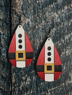 a pair of red and white leather earrings