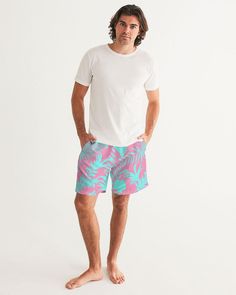 Men's Swimsuit, Tropical Foliage Pink and Teal Blue Pink and Teal Tropical Floral Leaf swim trunks. Bright turquoise blue and vibrant pink tropical foliage print Product Details Head to the beach in our classic fit Men's Swim Trunks made with comfort in mind. With an adjustable drawstring waistband, its smooth and durable materials made with UPF 50+ gives you premium UV protection. Soft, lightweight fabric Drawstring waistband UPF 50+ Built-in mesh brief Two side, one back slip pocket Printed, c Tropical Swimwear With Relaxed Fit For Vacation, Tropical Style Relaxed Fit Swimwear For Vacation, Tropical Relaxed Fit Swimwear For Vacation, Casual Pink Swimwear With Tropical Print, Pink Tropical Style Shorts For Poolside, Tropical Pink Swim Trunks For Beach, Pink Tropical Print Casual Swimwear, Casual Pink Tropical Print Swimwear, Pink Relaxed Fit Beachwear Swimwear