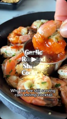 someone is dipping shrimp into a sauce in a skillet