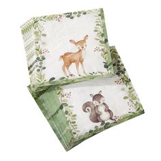 two napkins with deer and squirrel designs on them, one is folded to the side