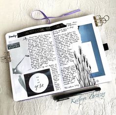 an open book with writing on it next to a pair of scissors and a pen