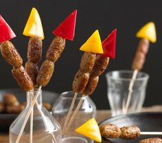 several skewers with different shapes and sizes are on sticks in glass vases