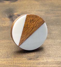 a white and brown object sitting on top of a wooden table