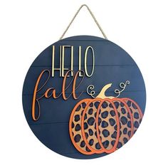 a sign that says hello fall and has leopard print pumpkins hanging from the front