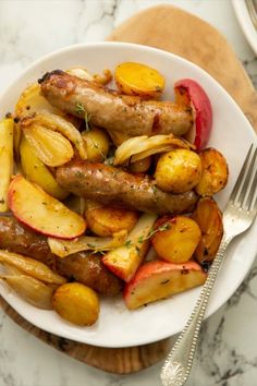 a white plate topped with sausage and potatoes