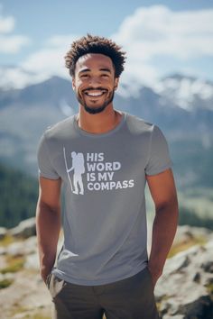 A unisex jersey short sleeve tee with the inspiring message 'His Word Is My Compass'. Relevant for those seeking faith-based inspiration and comfort. Perfect for gifting during religious holidays and occasions. This classic unisex jersey short sleeve tee fits like a well-loved favorite. Soft cotton and quality print make users fall in love with it over and over again. These t-shirts have-ribbed knit collars to bolster shaping. The shoulders are tapered for a better fit over time. Dual side seams hold the garment's shape for longer. .: Made with 100% Airlume combed and ring-spun cotton, a lightweight fabric (4.2 oz/yd² (142 g/m that is easy to layer, breathable. Perfect for active and leisure wear.  .: The retail fit that is perfect for casual and semi-formal settings. The crew neckline add Gray Crew Neck T-shirt For Outdoor Activities, Short Sleeve T-shirt With Letter Print For Outdoor Activities, Cotton T-shirt With Letter Print For Outdoor Activities, Funny Text Short Sleeve T-shirt For Outdoor, Casual Outdoor T-shirt With Funny Text, Spiritual Shirts, Christian T Shirt, Leisure Wear, Jersey Shorts