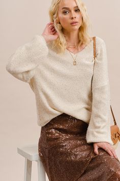 -Color: Cream -Soft touch polyester acrylic yarn with sparkling sequins -V-neck -Long sleeves -Loose fit -Ribbed on neck, cuffs and hem -Content: 65% Polyester 35% Acrylic -Imported -Model is 5'10" 31-25-35 and wearing a size Small Sequin Sweater, Acrylic Yarn, Sequin Skirt, Knitted Sweaters, Loose Fitting, Long Sleeves, Yarn, V Neck, Cream