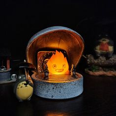 a fire is lit in an old fashioned oven on a table next to other items