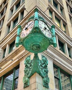 a green clock on the side of a building