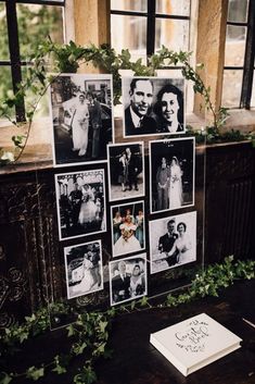 wedding photos are hung on the wall in front of an old window with ivy growing over it