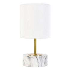 a marble lamp with a gold base and white lampshade on the bottom one side