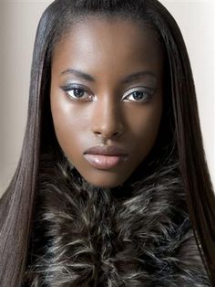 a woman with long hair wearing a fur collar