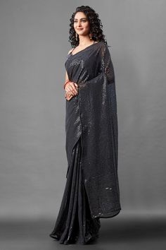 Attrective Look This Pretty Elegant Looking Designer Party Wear Saree In Black Color Paired With Blouse. This Saree Are Georgette And Blouse Are Banglori Silk Based With Designer Sequence Embroidery Work Beautified Saree. Buy Now.Product Features:  Saree Color: Black Blouse Color: Black Saree Fabric: Georgette Blouse Fabric: Banglori Silk Style Name: Designer Work: Sequence Embroidery, Piping Border Occasion: Partywear Size: Saree Length:-5.5 M Blouse Length:-0.80 M Wash Care: Dry Clean Disclaim Festive Pre-draped Saree With Zari Work For Party, Traditional Pre-draped Saree For Festive Party, Party Pre-draped Saree With Mirror Work In Art Silk, Festive Party Wear Pre-draped Embroidered Saree, Party Floor-length Art Silk Pre-draped Saree, Embroidered Georgette Pre-draped Saree For Party, Evening Saree With Unstitched Blouse For Eid, Semi-stitched Sequined Saree, Eid Evening Saree With Unstitched Blouse